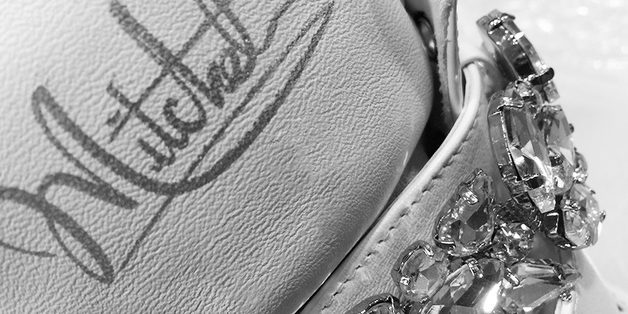 Mitchell signature embroidery beside a crystal beaded trim on a sheepskin boot