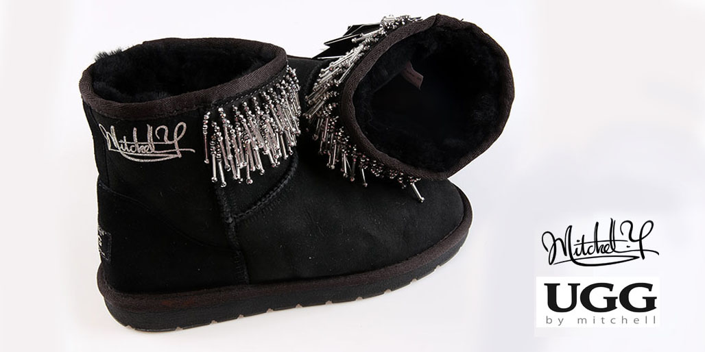 Black boot with beaded fringe, angled view