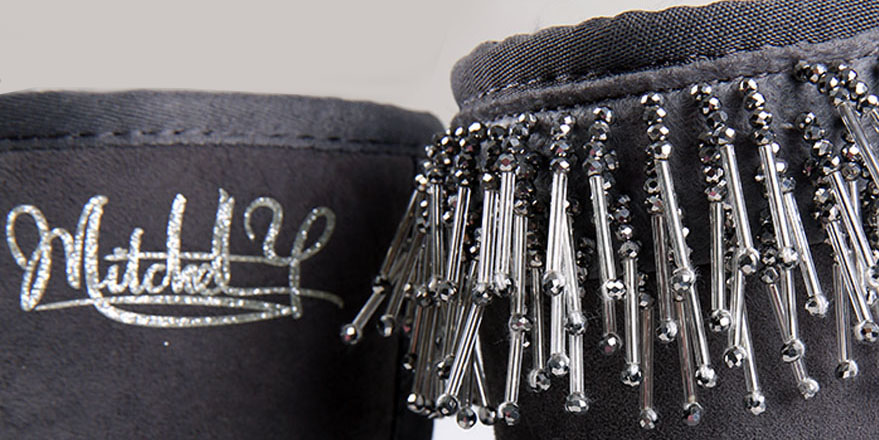 Silver beaded fringe and Mitchell signature embroidery on a black suede cuff